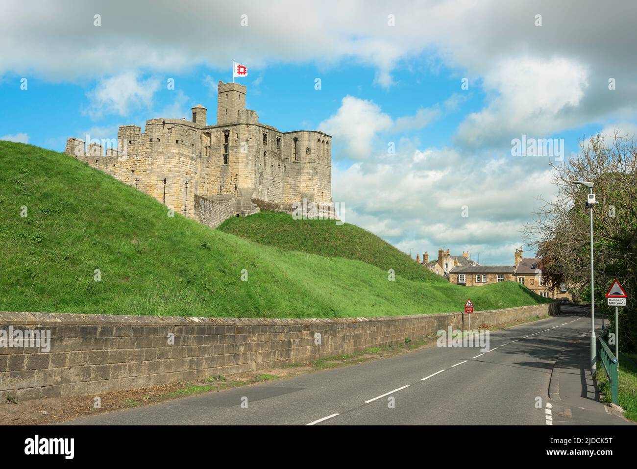 Warkworth Castle, view in summer of the partially ruined hilltop medieval castle sited in the centre of Warkworth Village, Northumberland, UK Stock Photo