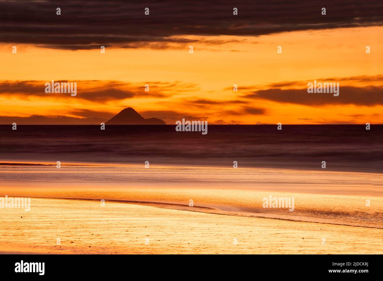 Tirohanga Beach, New Zealand, Bay of Plenty After glow with Moutohora Island silhouetted against an orange sky, Credit:Robin Bush / Avalon Stock Photo