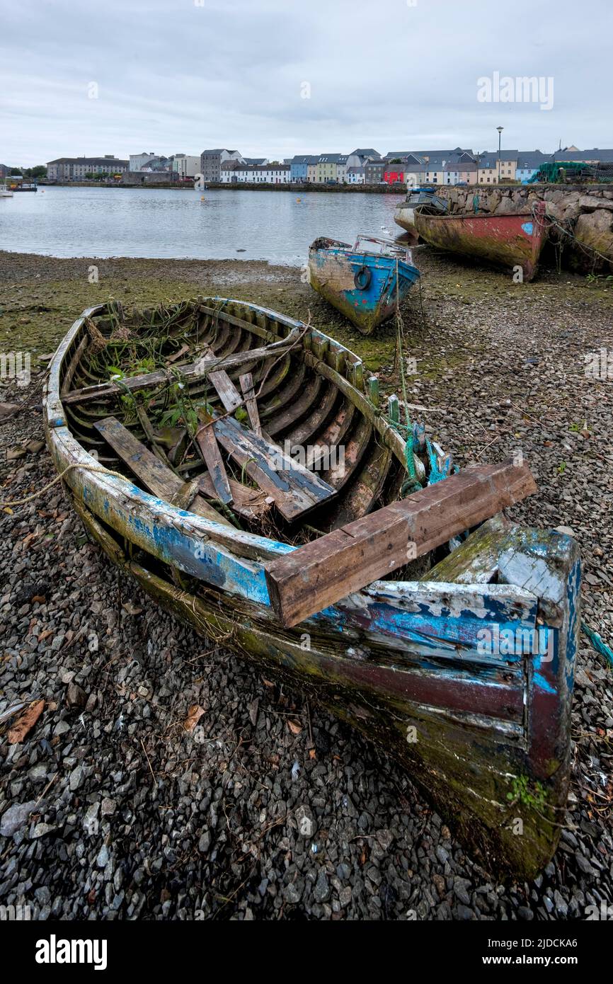 Broken boats, River Corrib toward colourful hoses of Spanish point, Galway City, Ireland, Credit:Robin Bush / Avalon Stock Photo