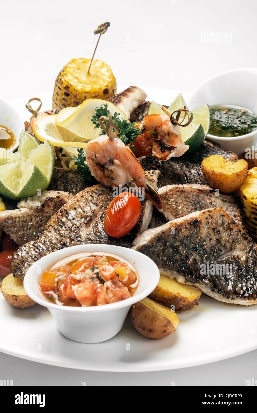 mixed fried fish plate with seared seabass and red snapper on white background Stock Photo