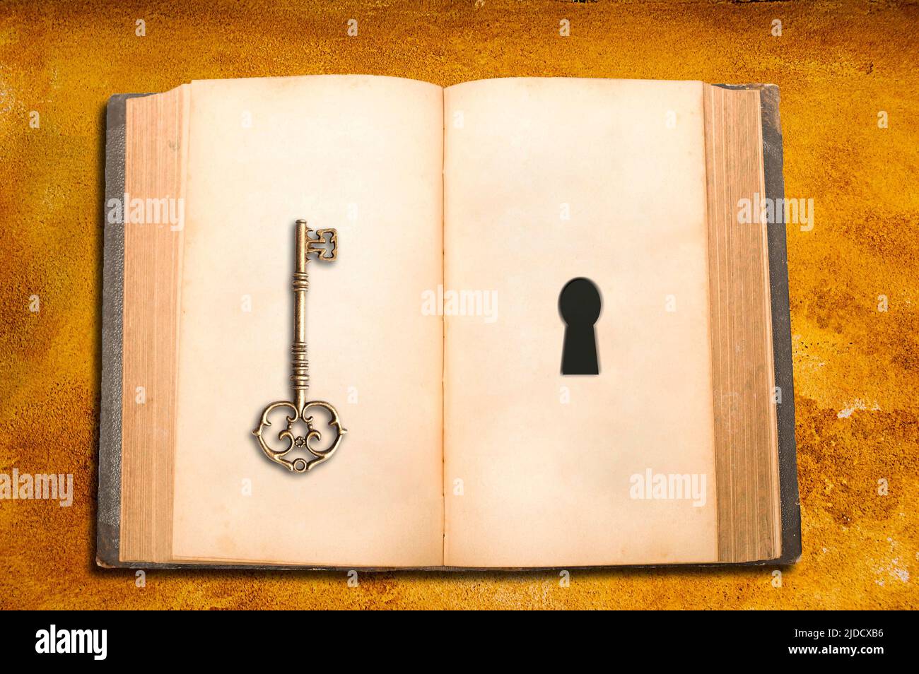 open book with blank pages and a key and a keyhole Stock Photo
