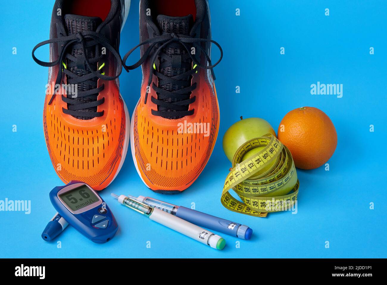 Orange sneakers, fruits, measuring tape, and insulin syringe