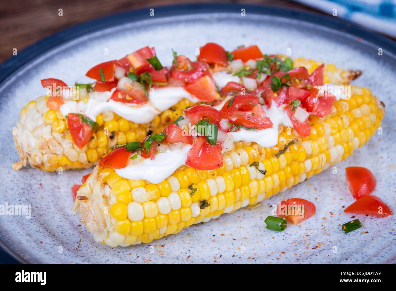 Elote delicious grilled mexican corn with cream cheese and pico de gallo salsa Stock Photo