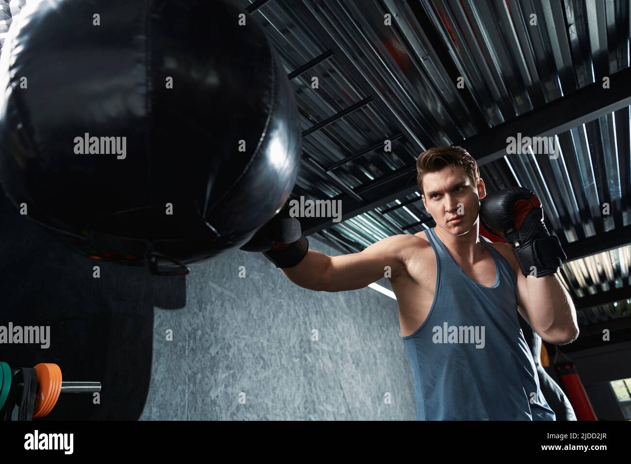 Serious concentrated boxer practicing punches during training session