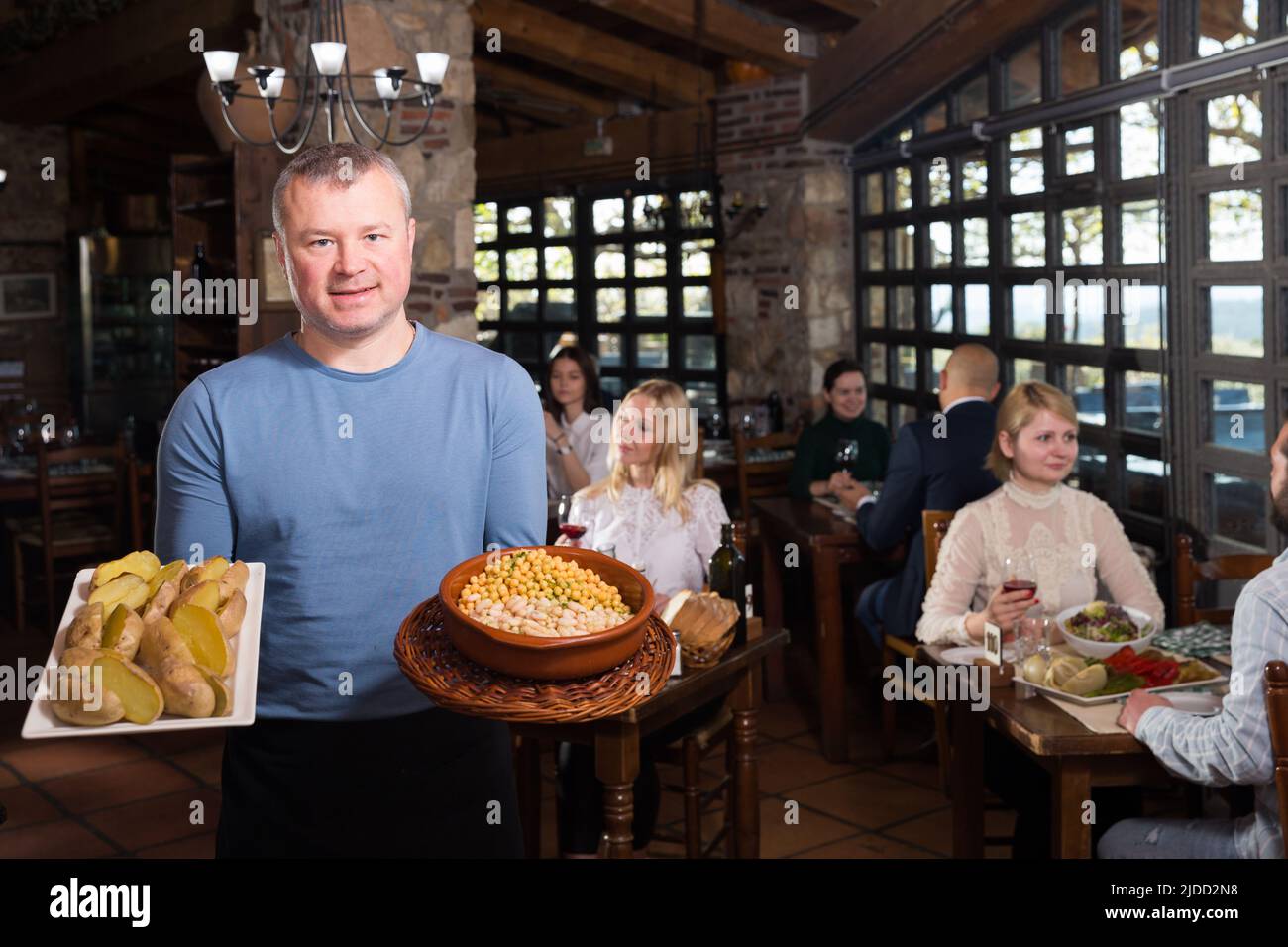 Country restaurant owner with traditional meals Stock Photo Alamy