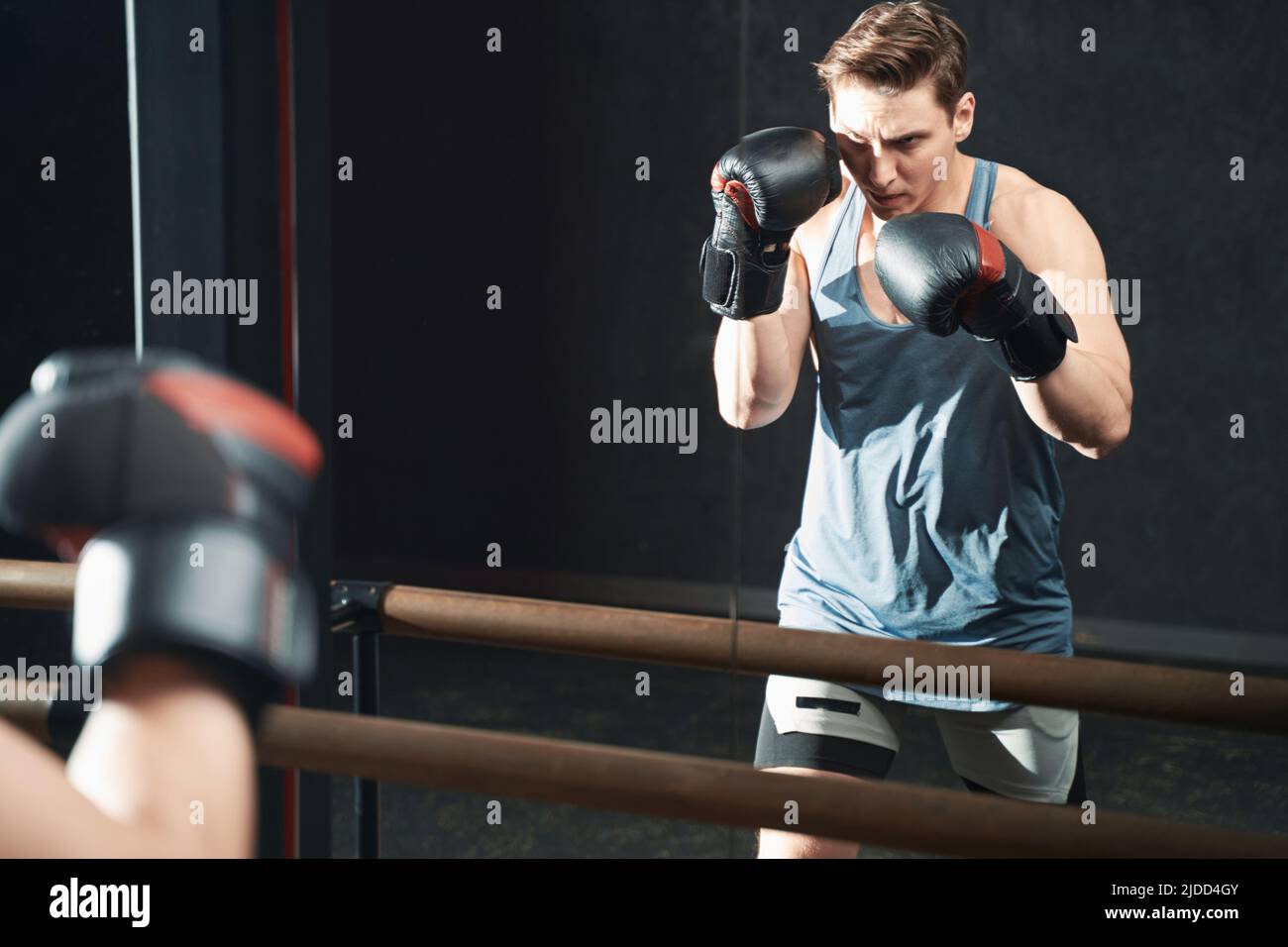 Purposeful professional boxer working out at gym Stock Photo
