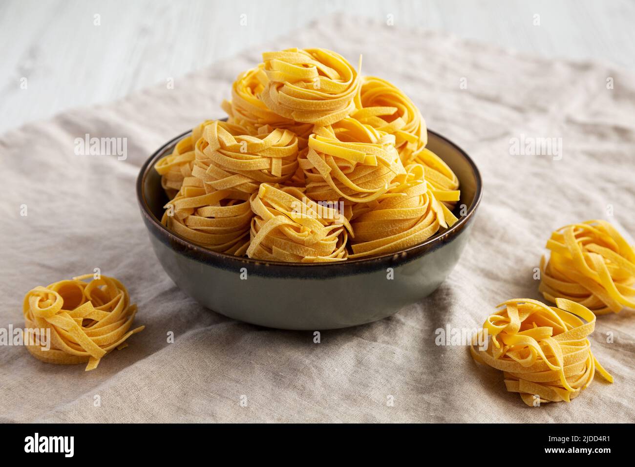 Homemade Organic Dry Tagliatelle Pasta in a Bowl, side view Stock Photo