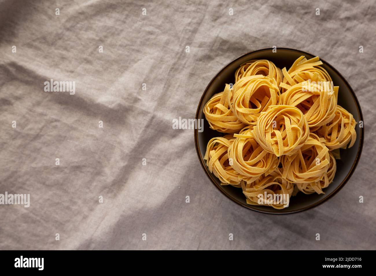 Homemade Organic Dry Tagliatelle Pasta in a Bowl, top view. Flat lay ...