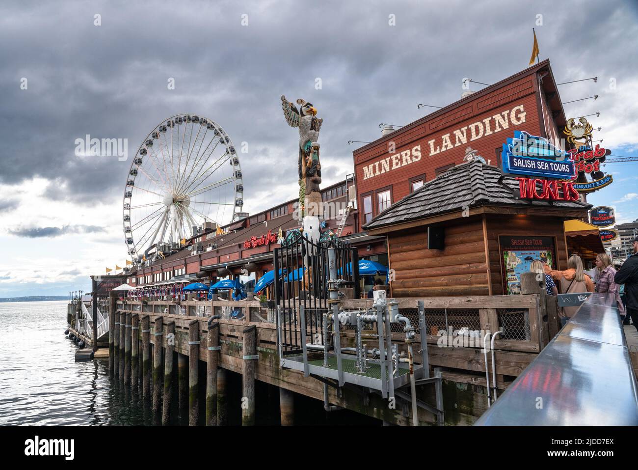 Seattle, Washington  USA - June 3, 2022:  Seattle Washington View from waterfront pier with restaurant and Ferris wheel in view Stock Photo
