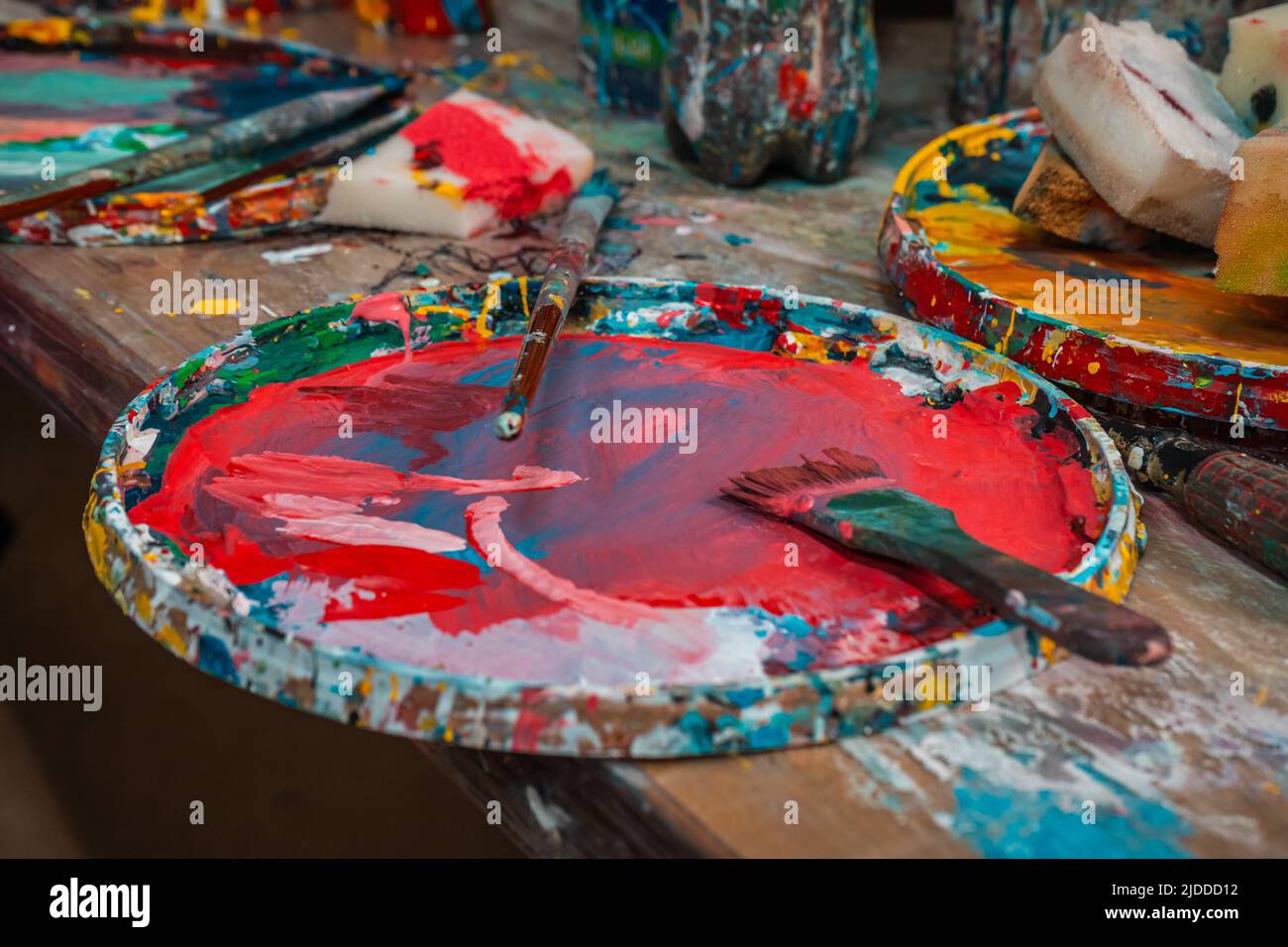 Bright colors in the palette and brushes in the art Stock