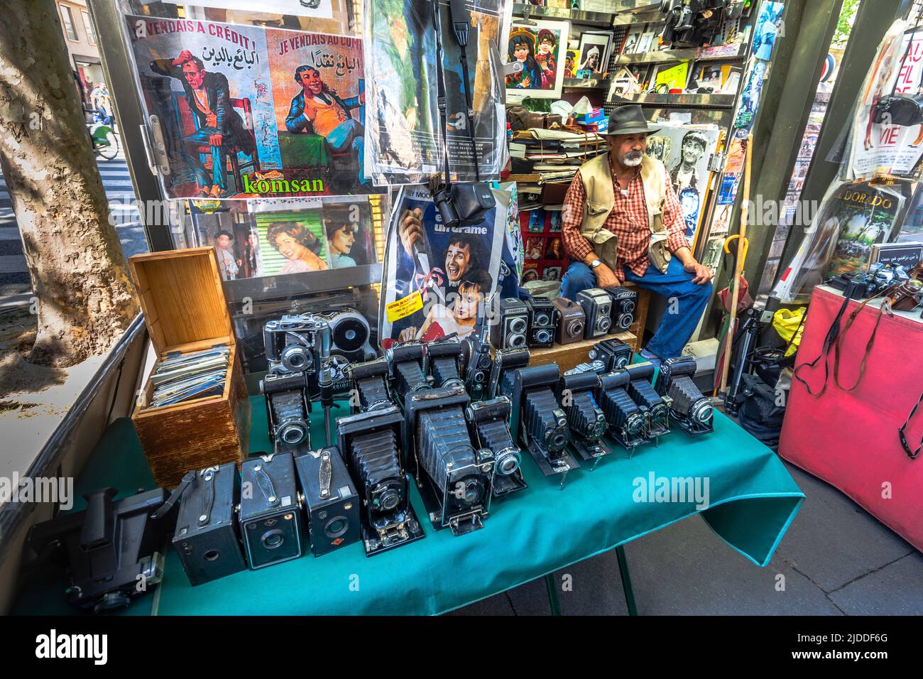 Stall on Parisian street with old folding film cameras for sale Paris