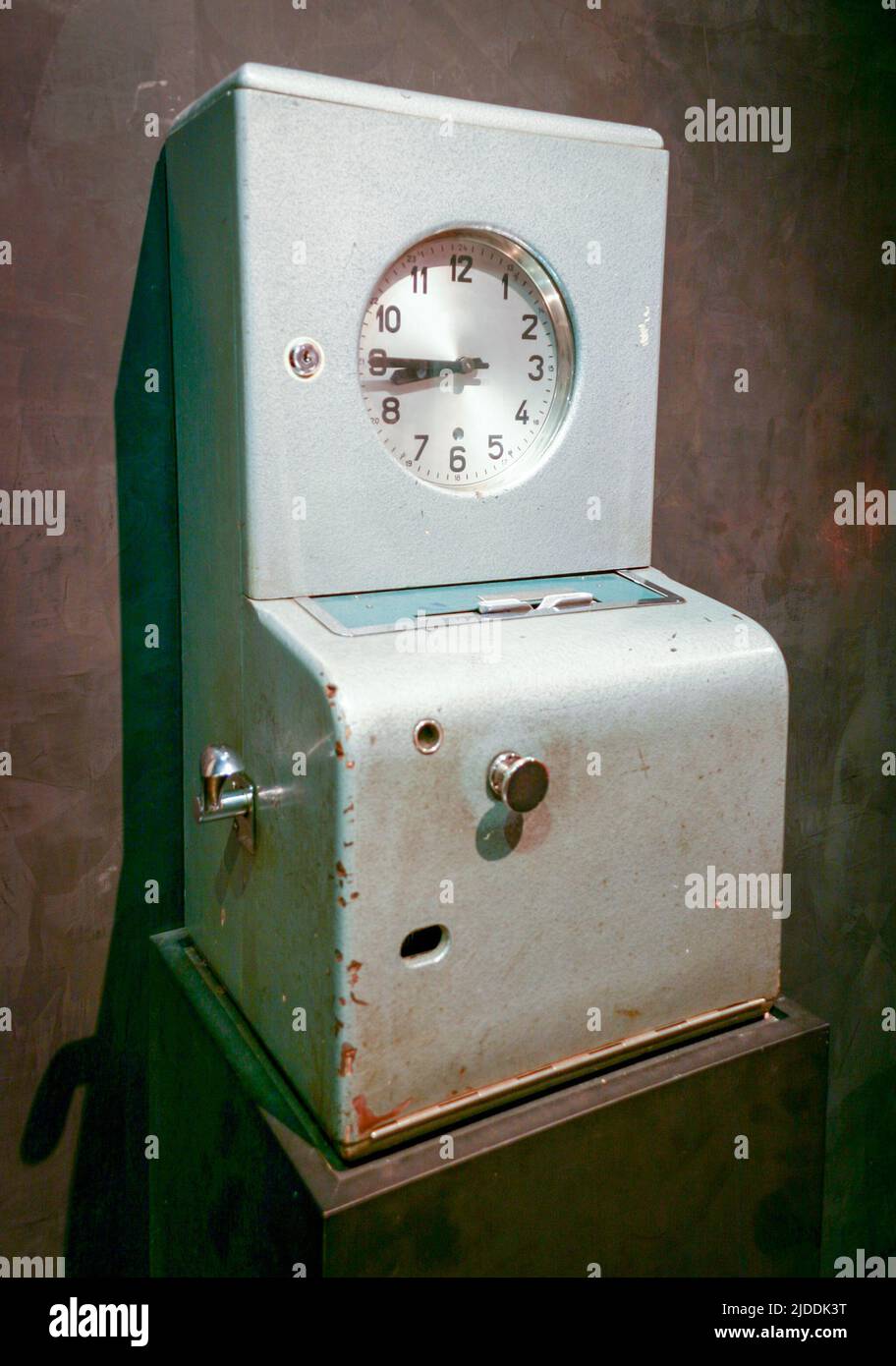 Vintage factory time / punch clock. A retro time clock / vintage punch clock is a device that