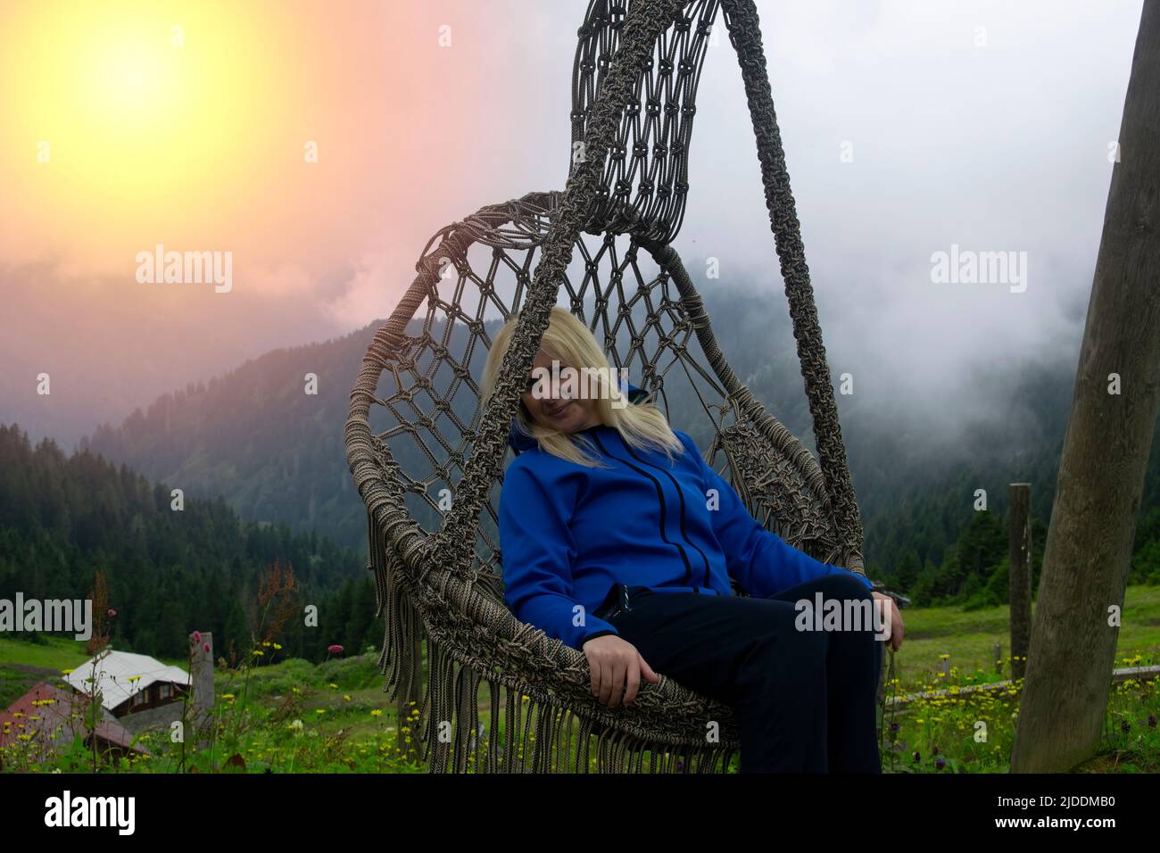 Rize, Turkey - July 2016: A young woman resting in a hammock in Pokut ...
