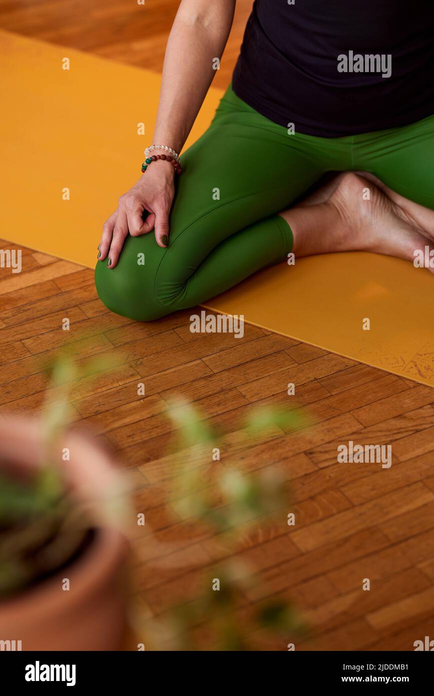 Healthy Beautiful Red Haired Woman Doing Yoga Exercises At Home On Floor,  Sitting On Mat In Lotus Position With Eyes Closed And Arms Up Breathing  Deeply And Relaxing Stock Photo, Picture and