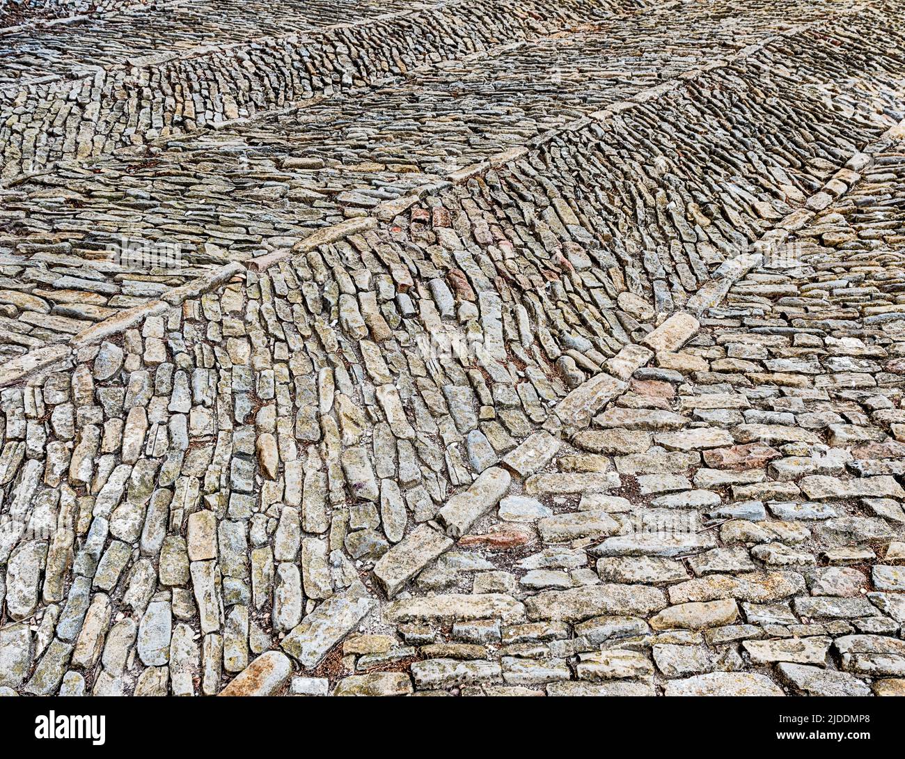 Courtyard stones are arranged in an interesting pattern at the castle in Serralunga. Stock Photo