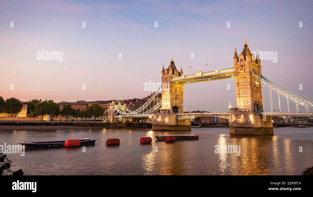 A dusk view over the River Thames, London, with the iconic landmark Tower Bridge dominating the scene. Stock Photo