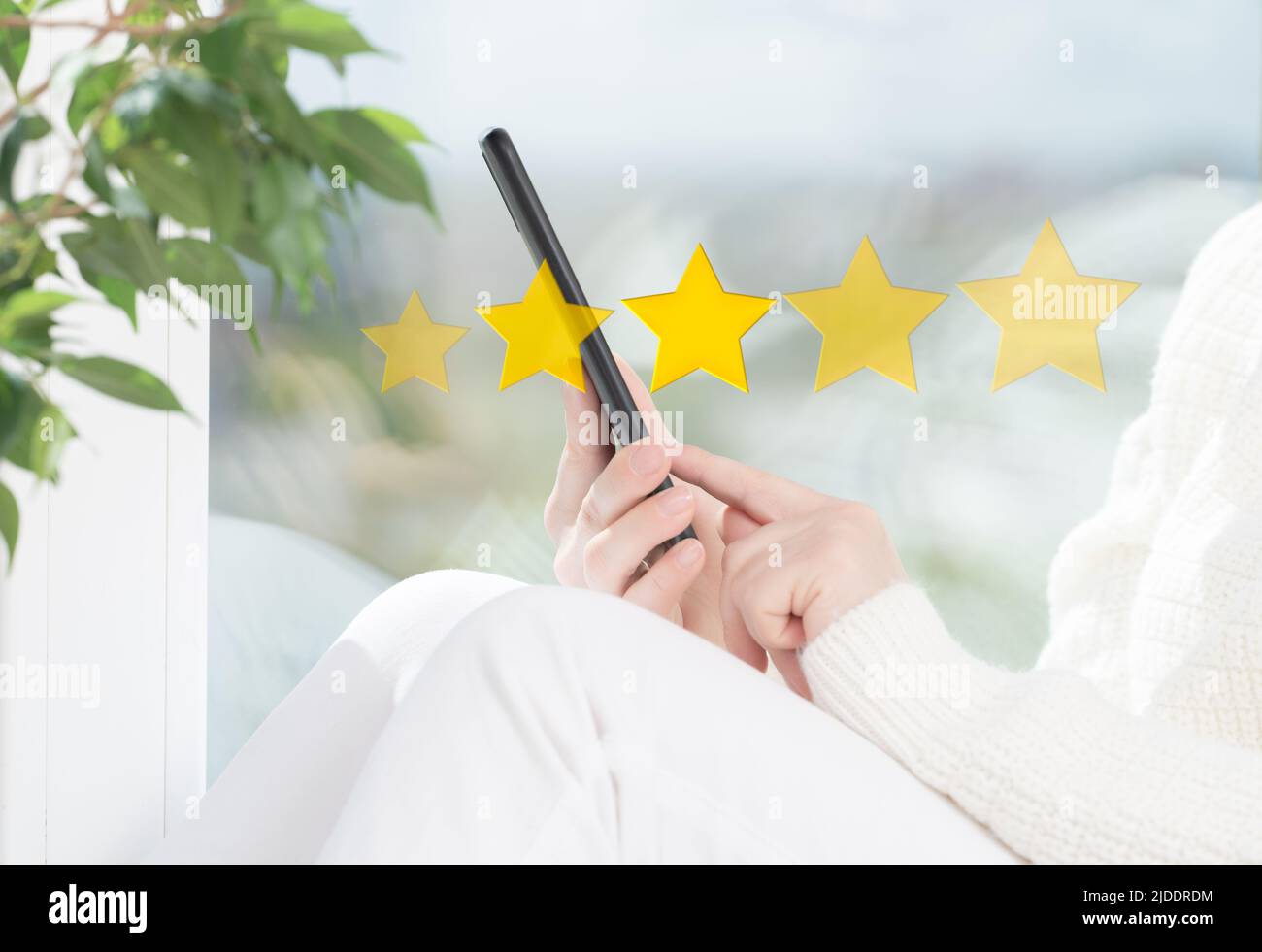 customer woman hand pressing on cellphone screen with gold five star rating feedback icon and press level excellent rank for giving best score point t Stock Photo