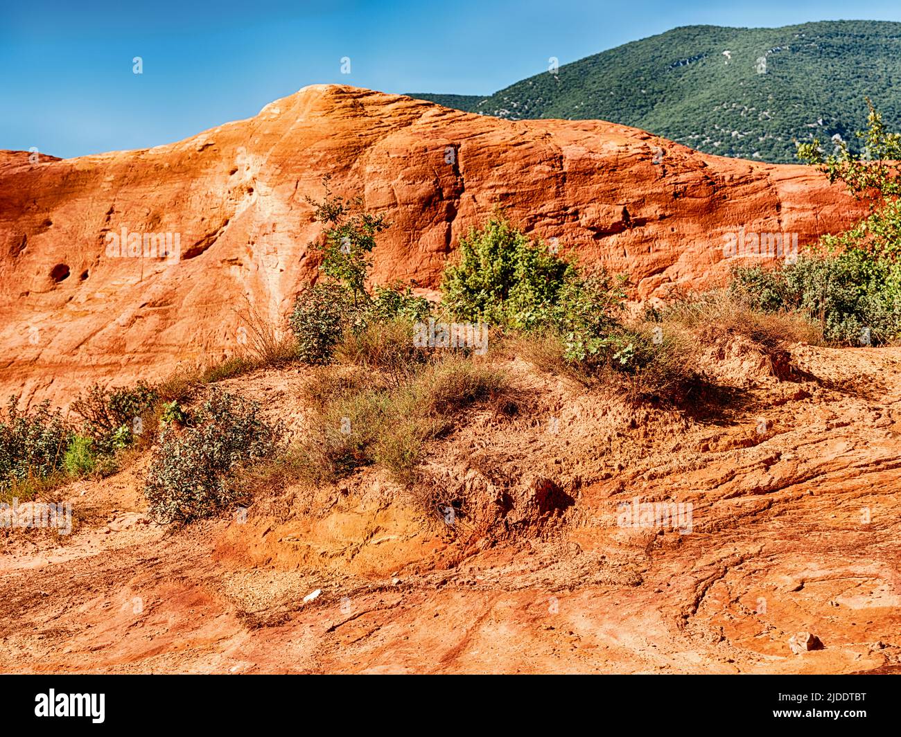 Rustrel, in the Luberon, is known for the canyons and badlands of red clay that lie outside the town. Stock Photo