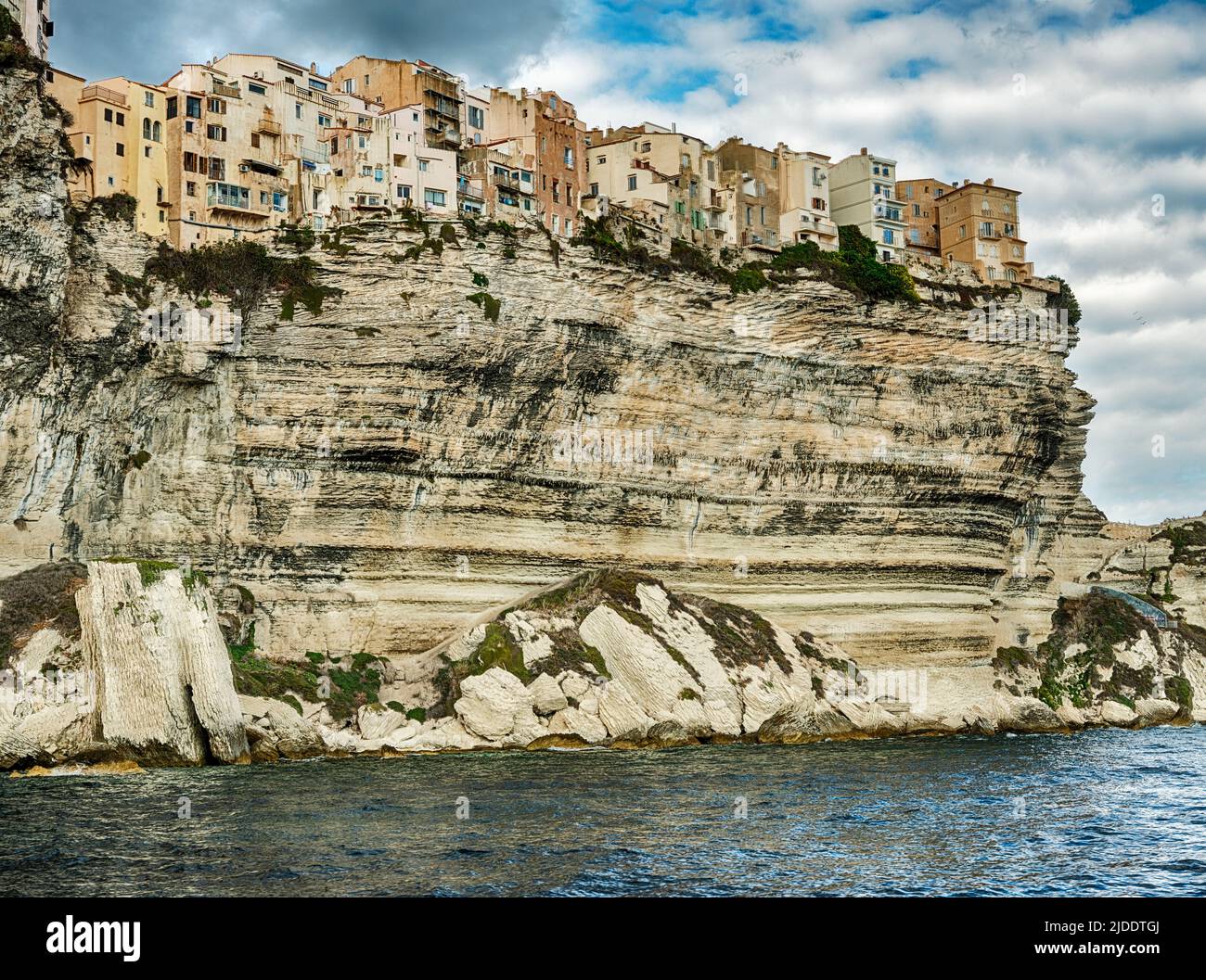The city of Bonifacio in Corsica is perched on the edge of stone cliffs looking over the Tyrrhenian Sea. Stock Photo