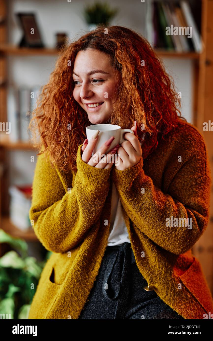 A Redhead Girl Enjoying Morning Coffee At Home A Happy Redhead Girl Standing At Her Cozy Home