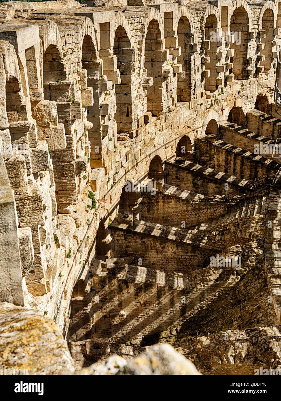 Shadows are thrown from seats againt the outer walls at the anicent Roman arena at Arles. Stock Photo