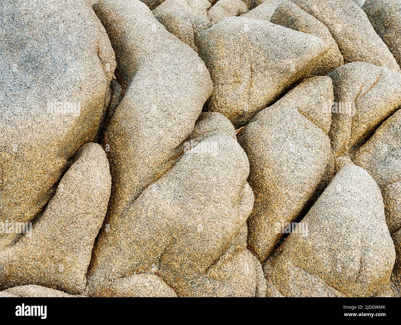 Granite beach boulders have been carved into unique shapes by the wind and water on Corsica. Stock Photo