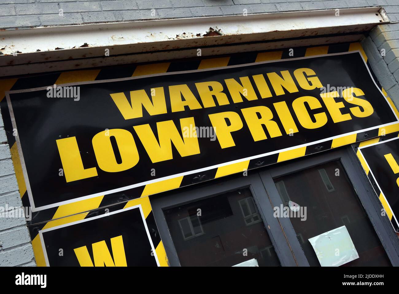 Sign announcing - Warning Low Prices are coming, Warrington, Cheshire, England, UK, WA1 Stock Photo