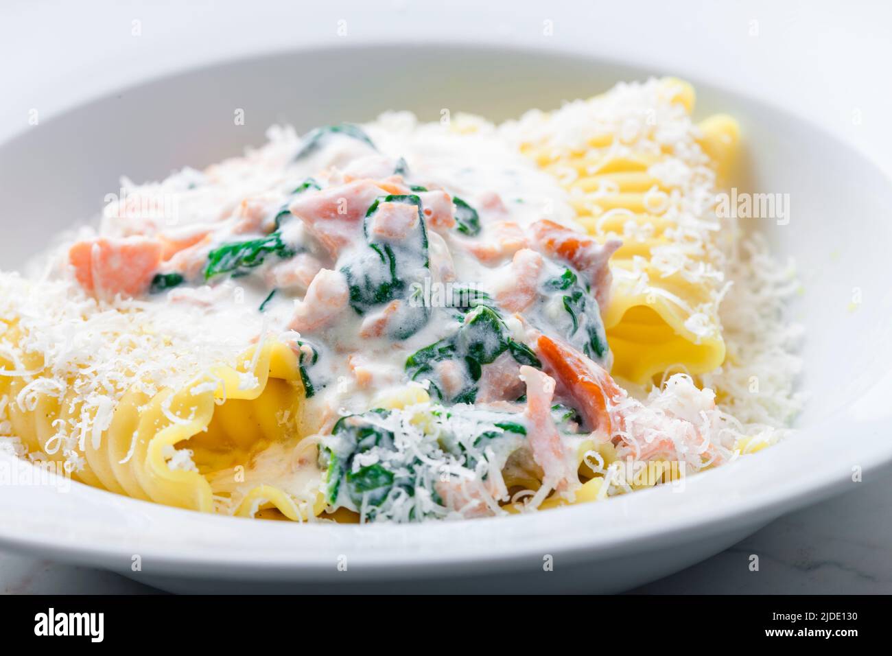 pasta with creamy salmon sauce with spinach Stock Photo - Alamy
