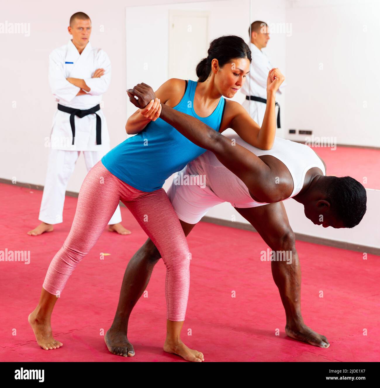 People training martial arts in gym with trainer Stock Photo Alamy