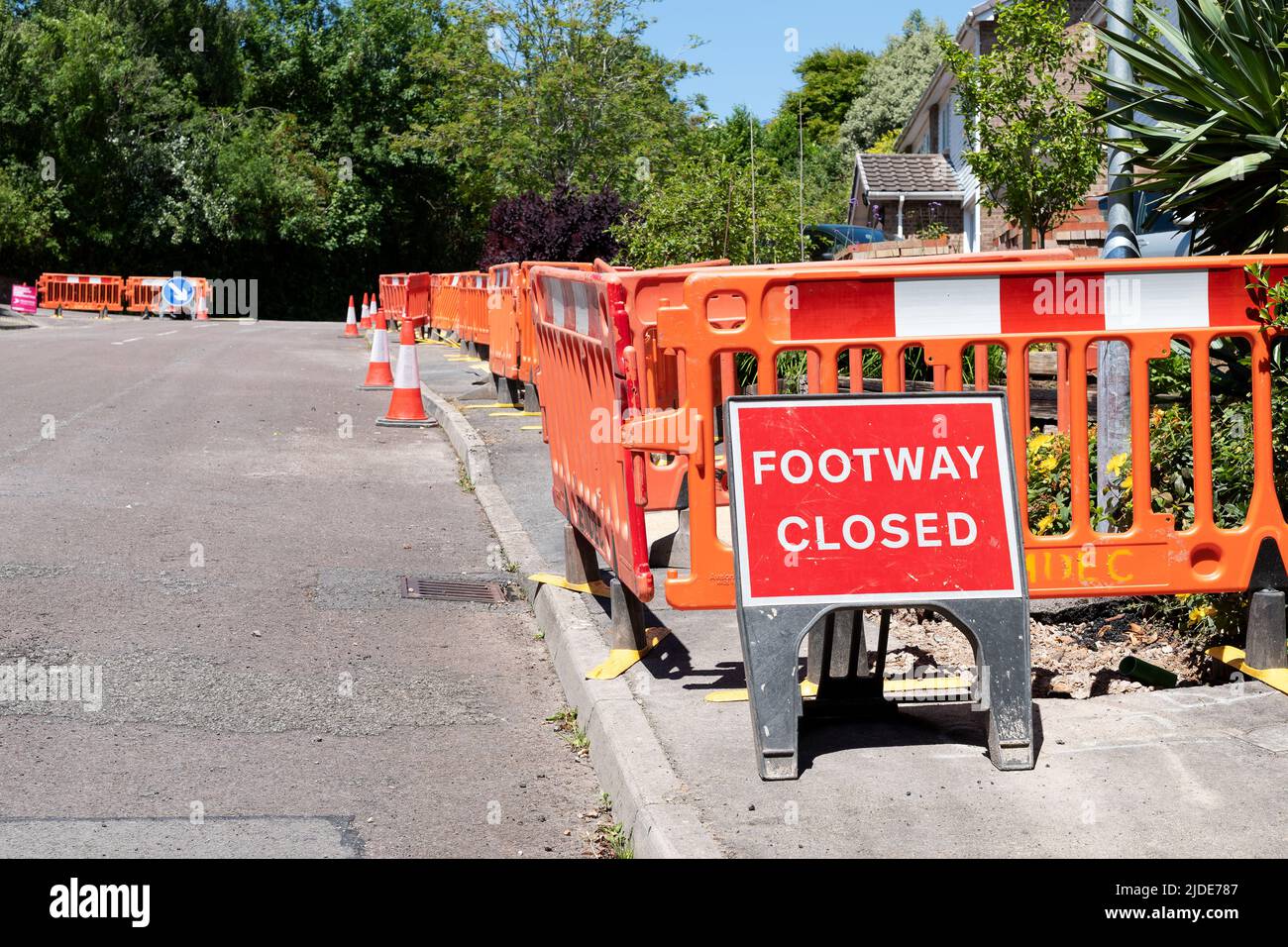 UK housing estate footpaths are closed and dug up whilst work goes ahead to update the estates homes to ultra fast broadband and digital phone lines Stock Photo