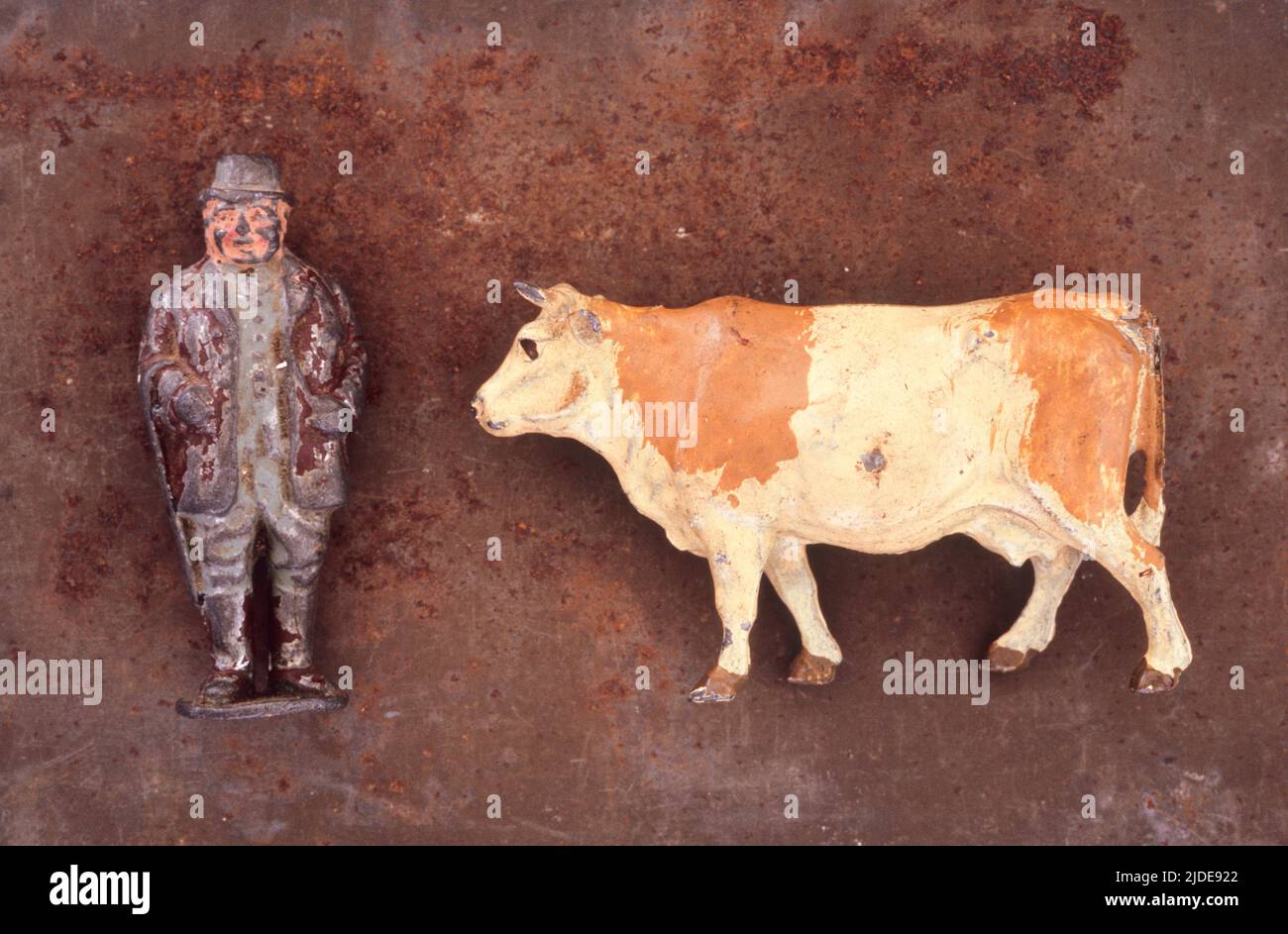 Close up of battered and scratched lead models of plump old farmer and ...