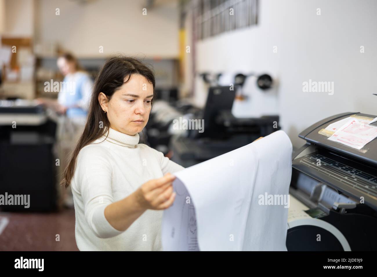 Worker in a printing and press centar check print quality Stock Photo