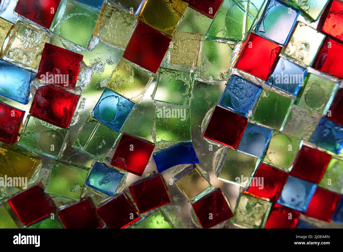 Colorful square glass mosaic stones glued on a glass plate. Meant as background Stock Photo