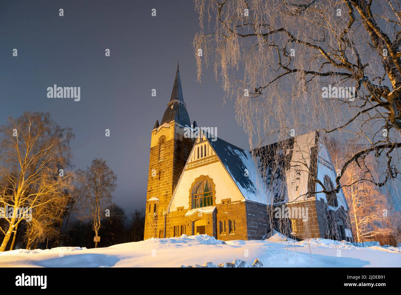 An old Lutheran church on a winter night. Melnikovo, Leningrad region. Russia Stock Photo