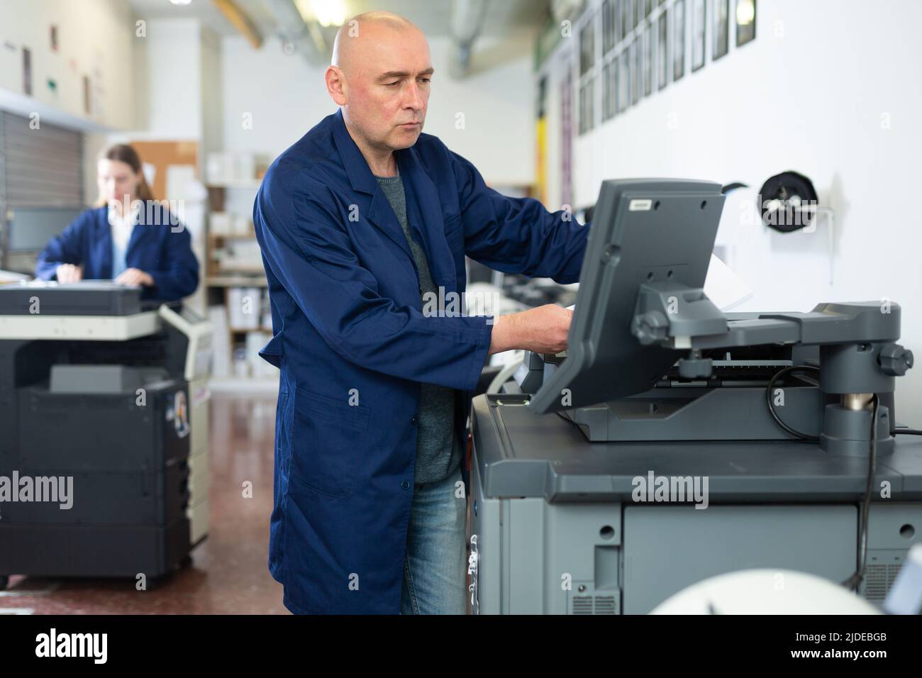 Man working in publishing facility Stock Photo
