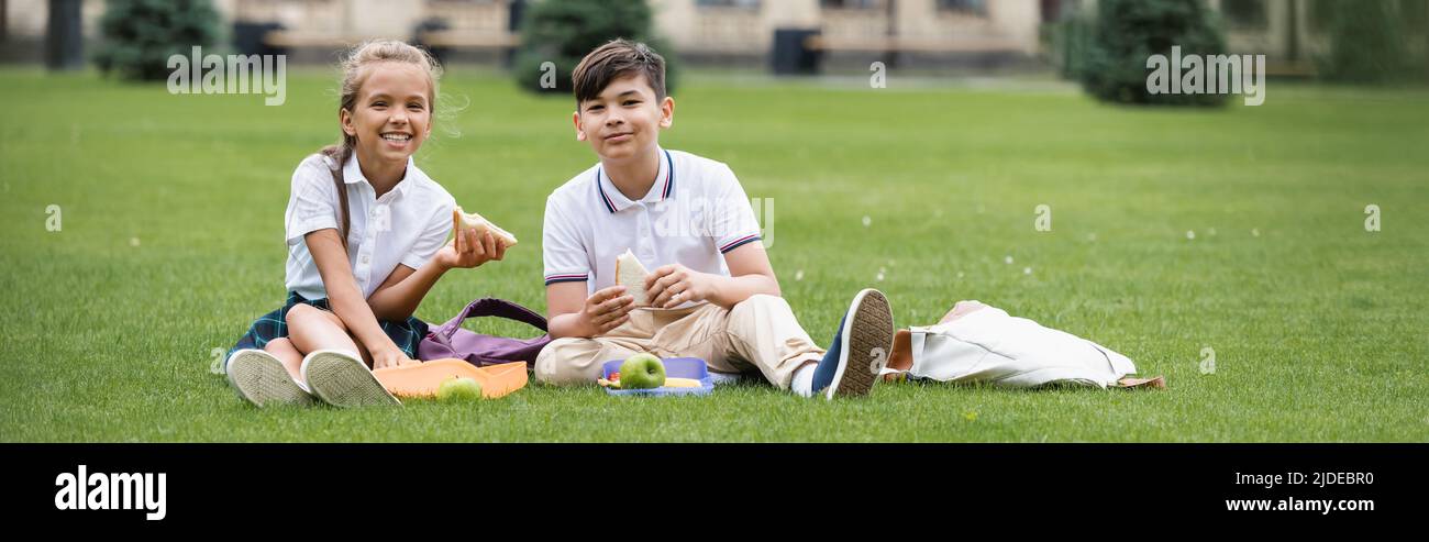 Happy kids together grass hi-res stock photography and images - Alamy