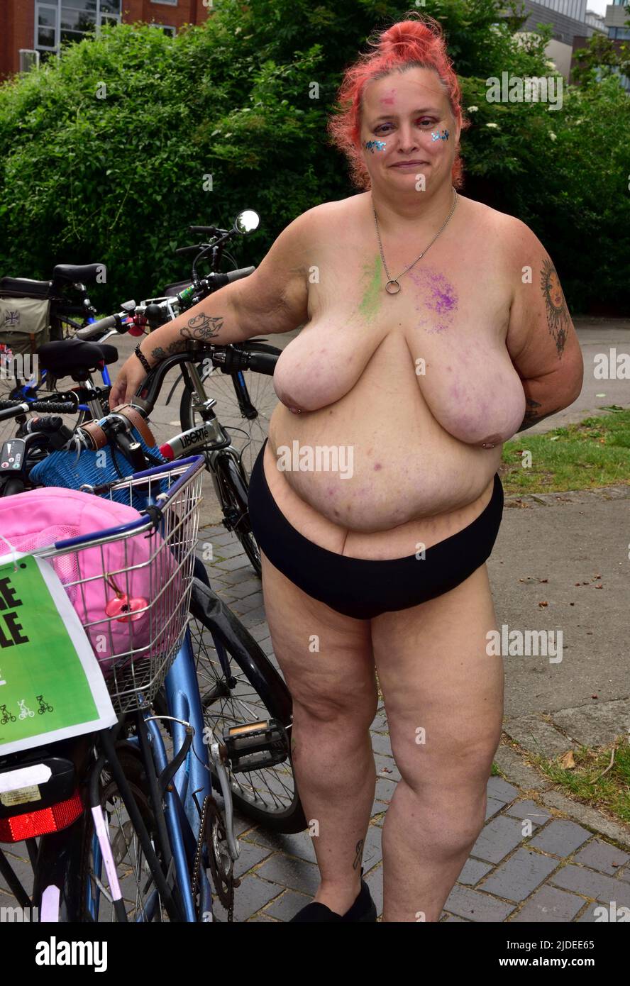 Woman participant in World Naked Bike Ride in Bristol 2022 during rest stop at Castle Park, Bristol, UK emphasizing everyone welcome and can be happy Stock Photo
