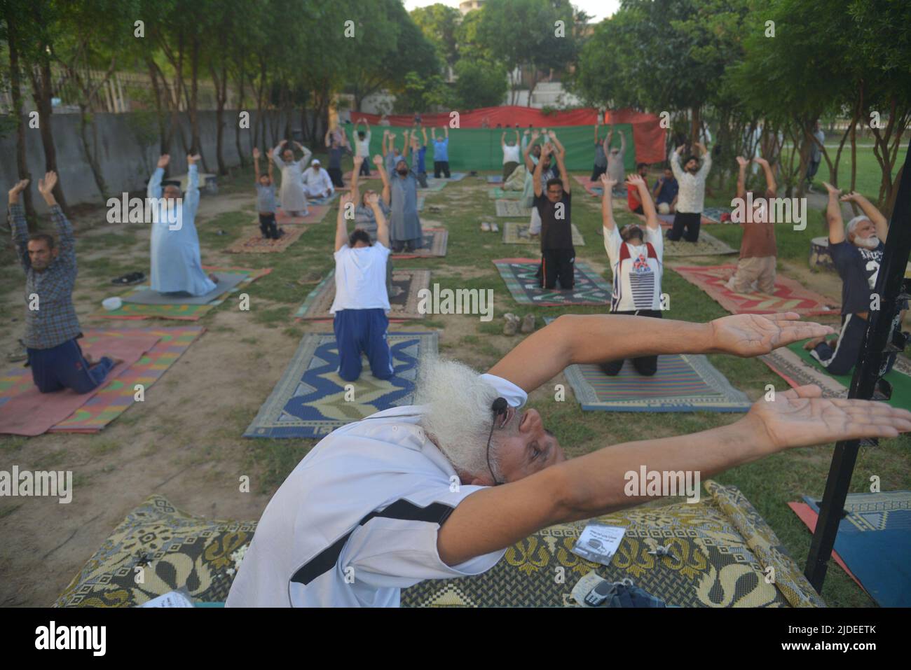 Lahore, Punjab, Pakistan. 20th June, 2022. Pakistani people performing yoga session at a ground on the eve of International Day of Yoga in Lahore. Millions of people worldwide took part in the Sixth International Day of Yoga. International Day of Yoga, or commonly and unofficially referred to as Yoga Day, is celebrated annually on 21 June since its inception in 2015. An international day for yoga was declared unanimously by the United Nations General Assembly (Credit Image: © Rana Sajid Hussain/Pacific Press via ZUMA Press Wire) Stock Photo