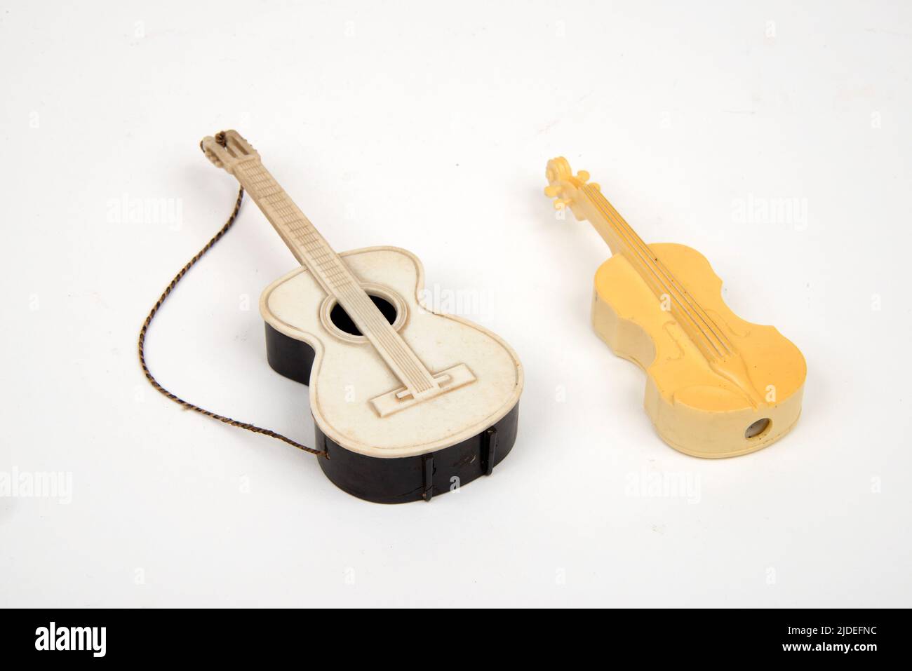 L/r Bakelite  and urea formaldehyde and styrene ivory-effect  novelty toy guitars Stock Photo