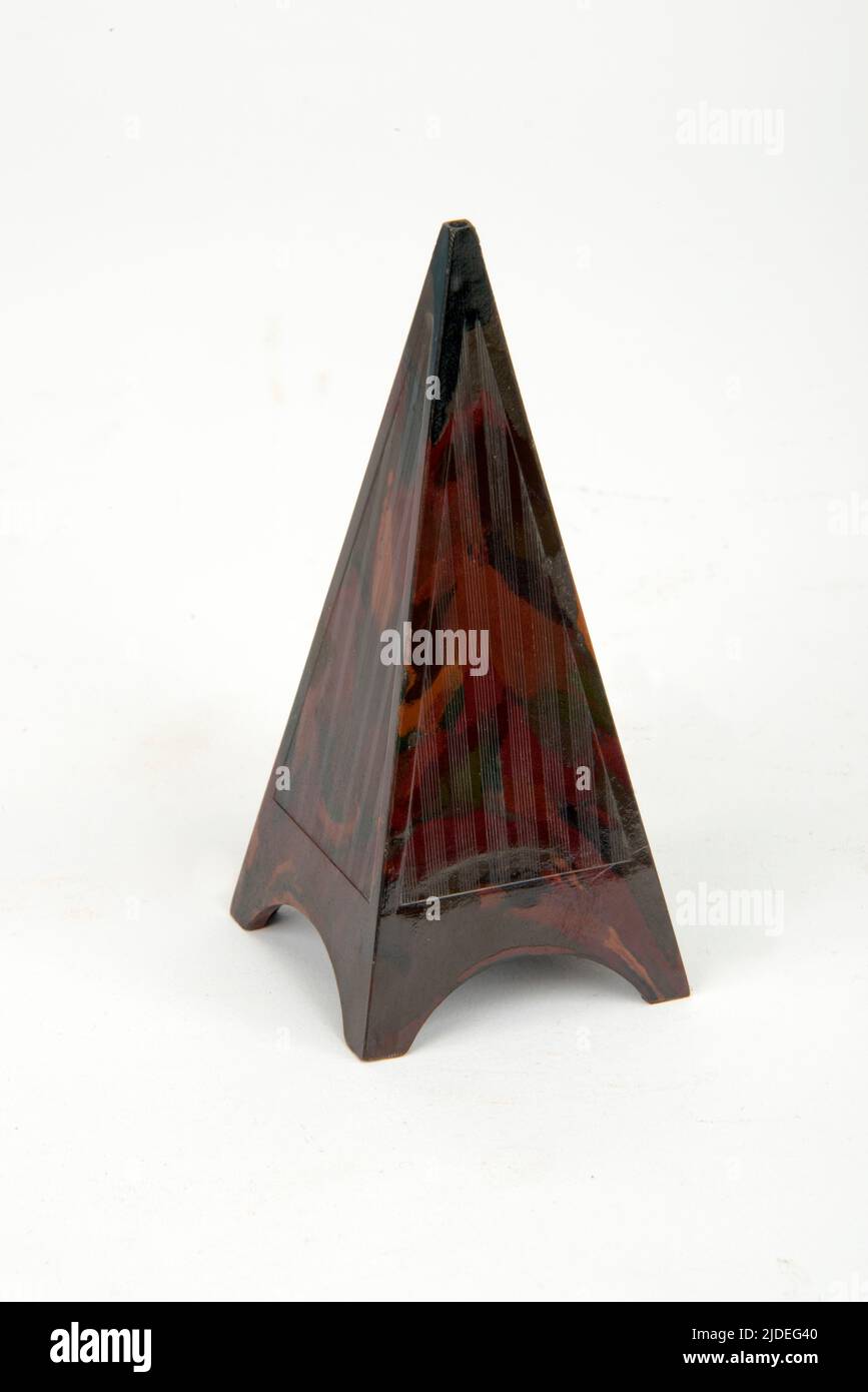 A selection of bakelite and plastic items.  Novelty pyramid salt cellar. Stock Photo