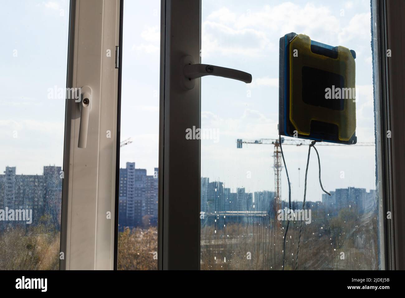 Robot window cleaner work on dirty window. Cleaning the house with