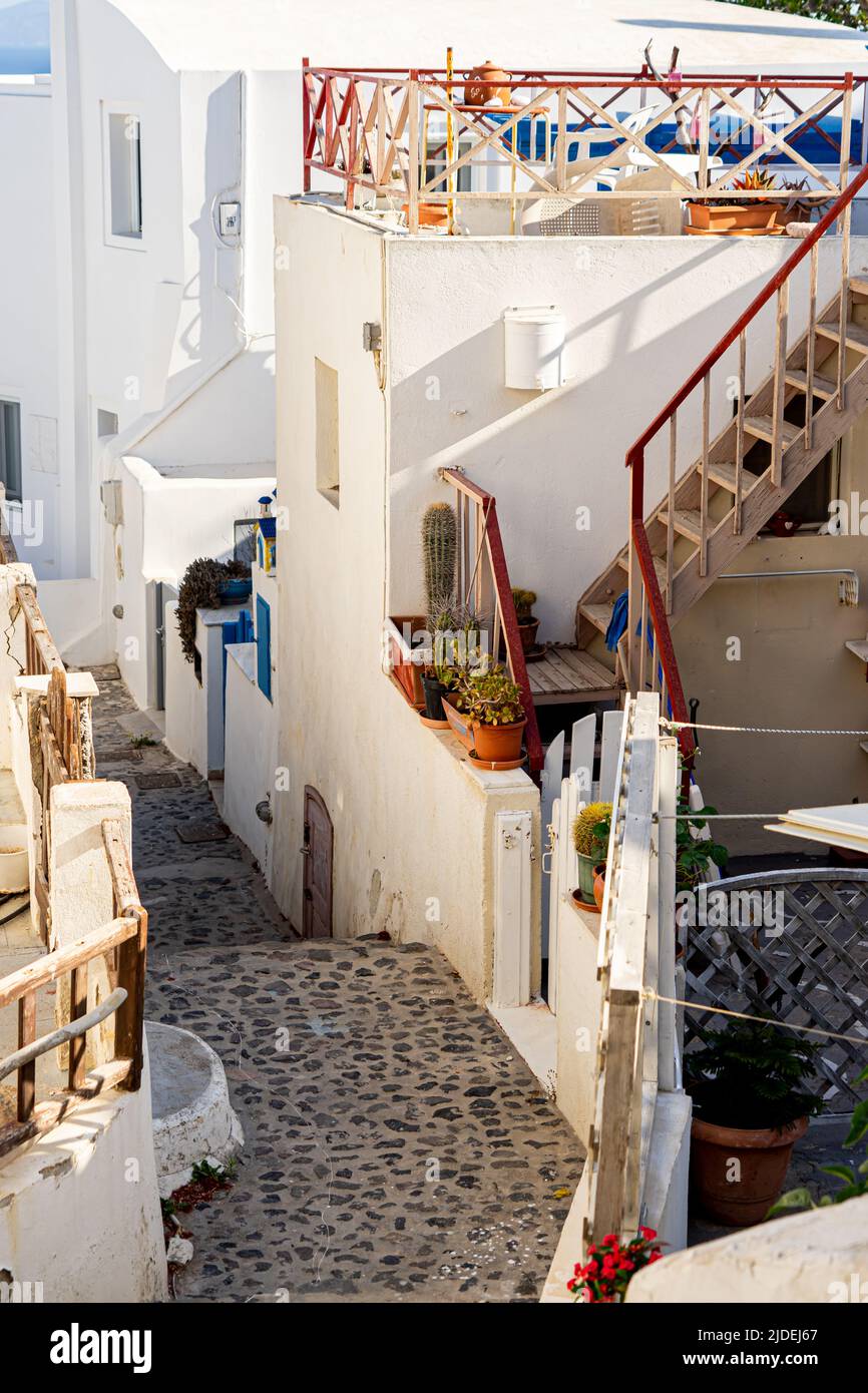 Narrow lane with colorful railings on patios and stairwells in iconic Oia on Santorini island Stock Photo