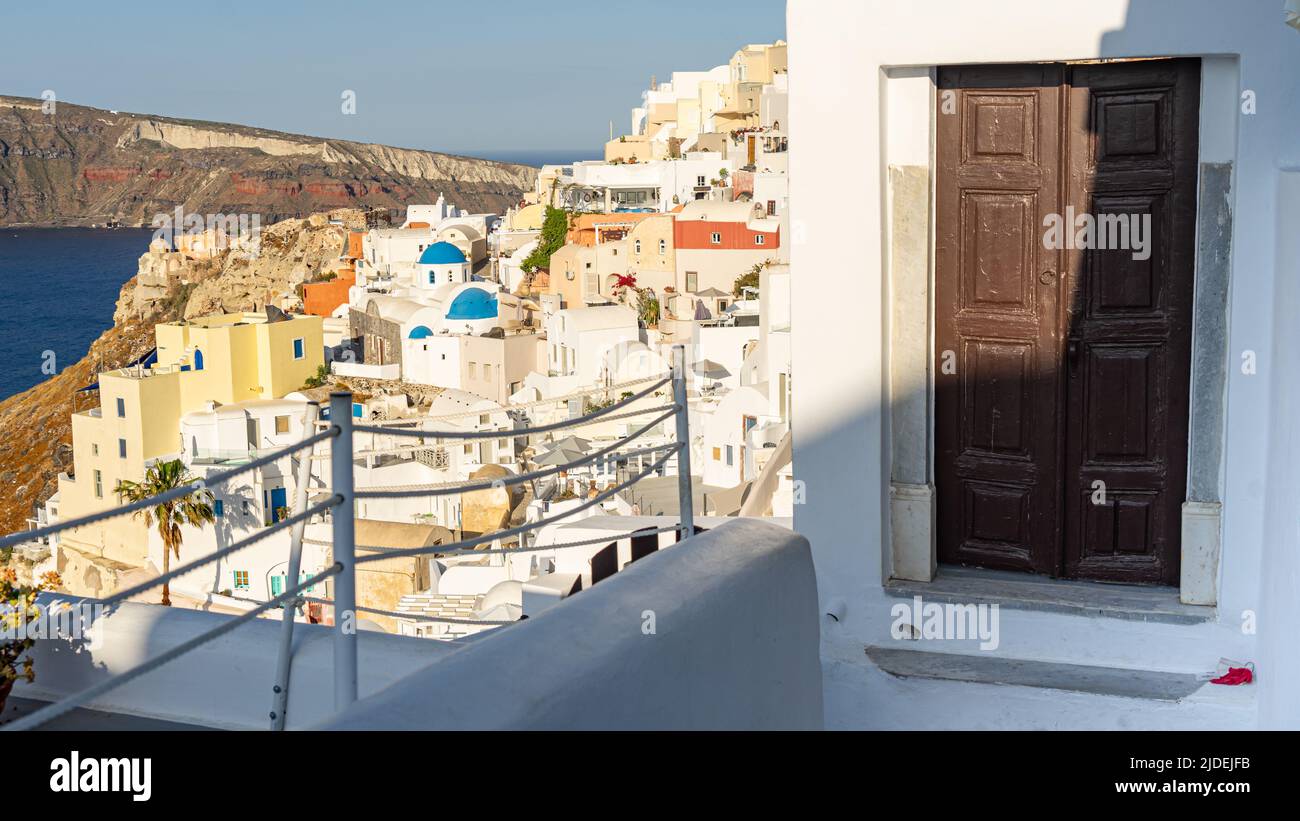 A view of the main part of Oia with an old gate in the foreground Stock Photo