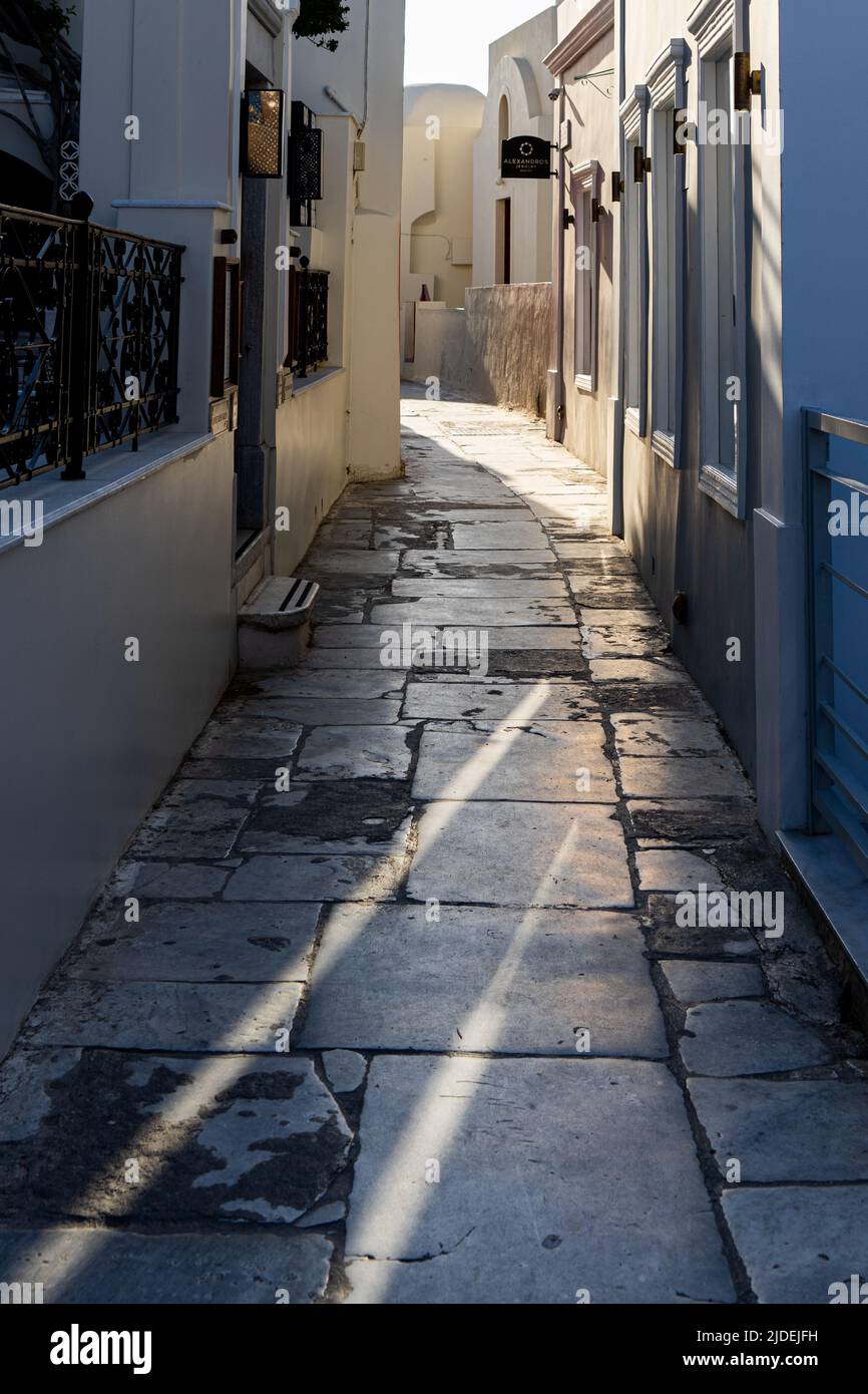 Sunbeams falling into a narrow street in Oia Stock Photo