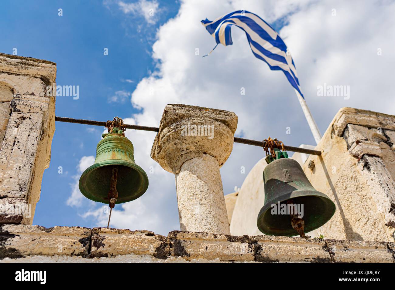 Bell tower with two bells and Greek flag in Oia Stock Photo