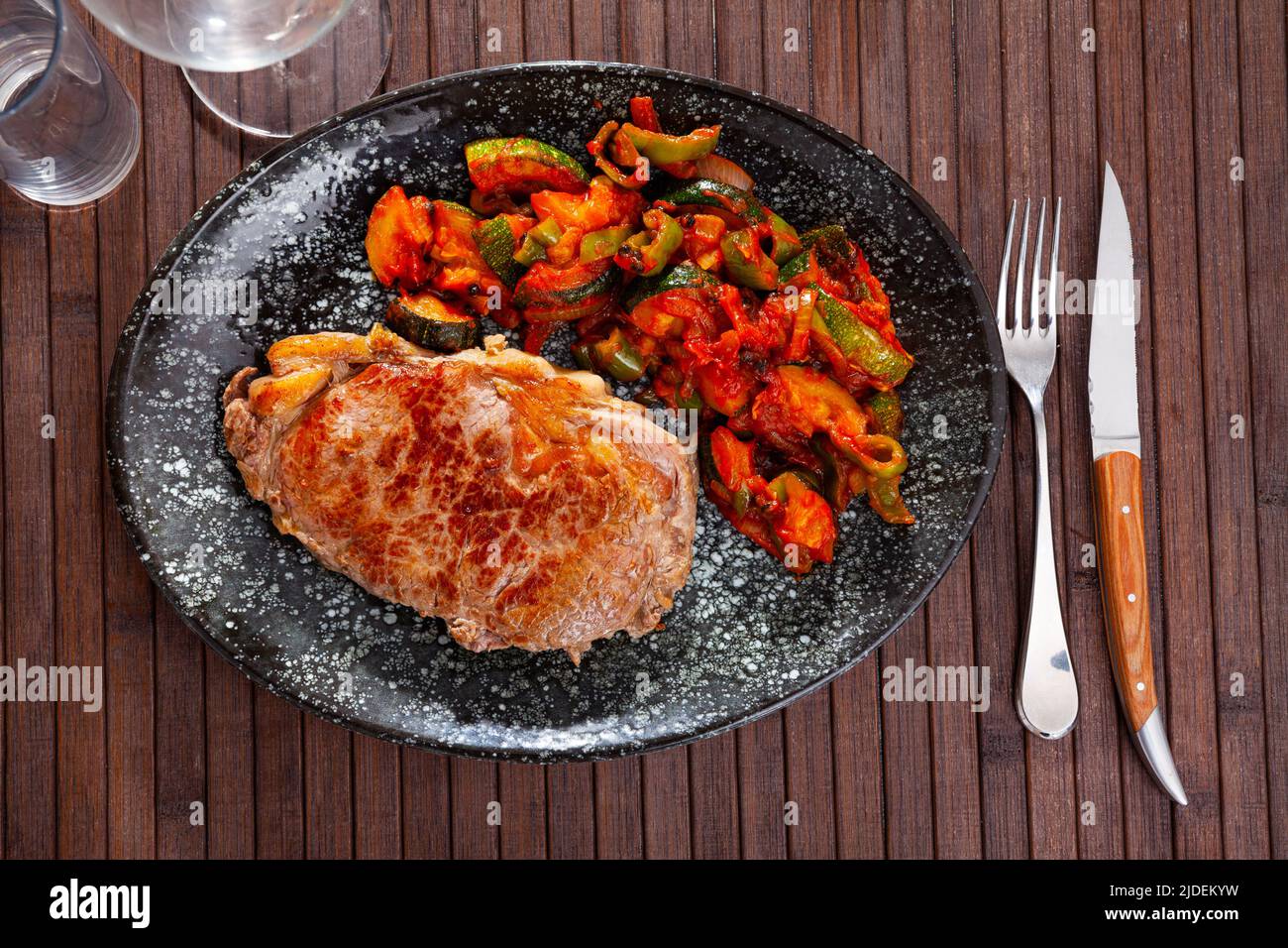 Roasted veal entrecote with side dish of stewed vegetables Stock Photo