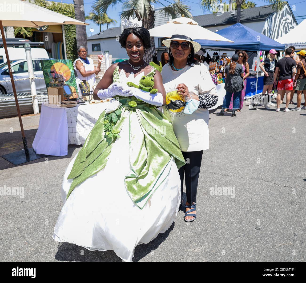 Santa Barbara, California, USA. 19th June, 2022. Juneteenth Santa Barbara celebration, at the 200 E. Grey Ave. block, on June 19, 2022. Pictured here as Princess Tiana from Princess and the Frog is Bria Bennett, aka The Chocolate Princess, next to Dianne Travis Teague, Director of Pacifica Graduate Institute's Alumni Relations, one of several sponsors of this year's Juneteenth event. Now an official national holiday in the USA, hundreds were in attendance celebrating the anniversary of the end of slavery, and promoting African American led businesses and non-profit serving the black communit Stock Photo