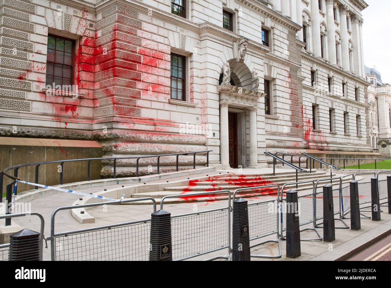 London ,United Kingdom  -13/06/2022. Demonstrators from Just Stop Oil have thrown red paint at the Her Majesty’s Treasury today as Police have cordone Stock Photo