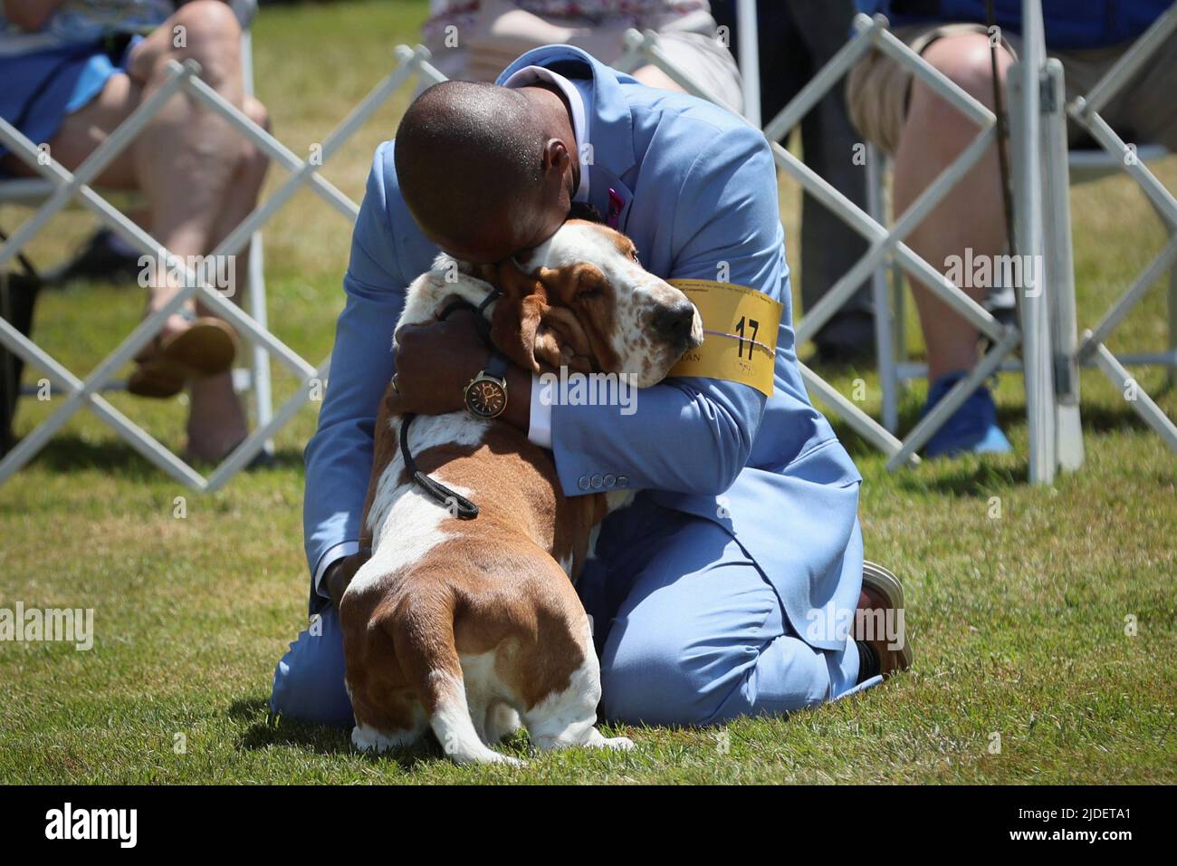 Handler Claudio Cruz embraces Ethan, a Basset Hound, after winning the 'Best of Breed' competition during breed judging at the 146th Westminster Kennel Club Dog Show at the Lyndhurst Estate in Tarrytown, New York, U.S., June 20, 2022. REUTERS/Mike Segar Stock Photo