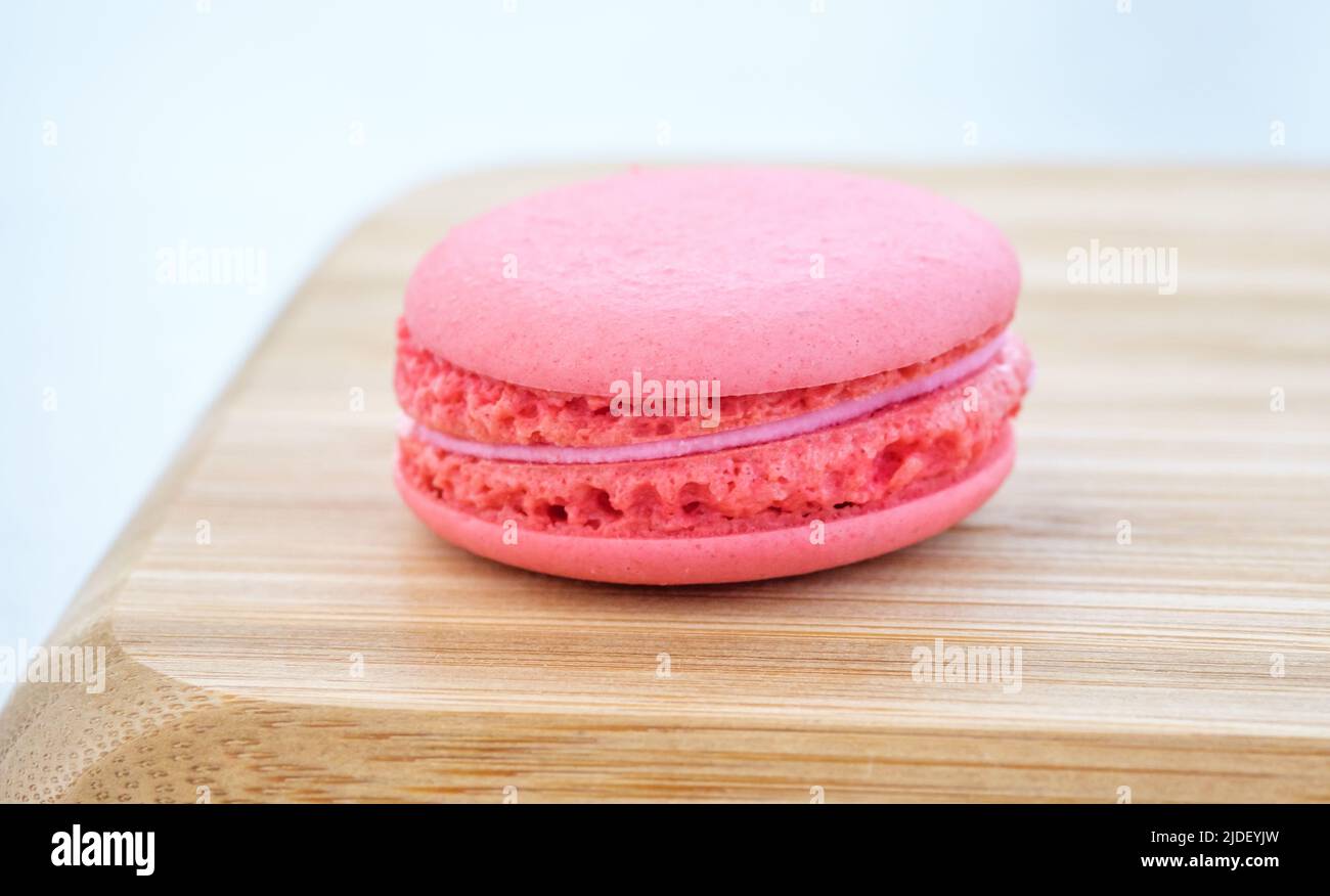 Pink raspberry macaroon on the wooden tray Stock Photo - Alamy
